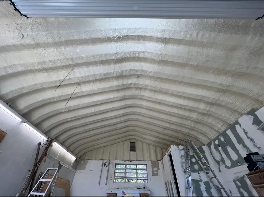 Spray polyurethane foam applied to the underside of a metal roof deck in Neosho
